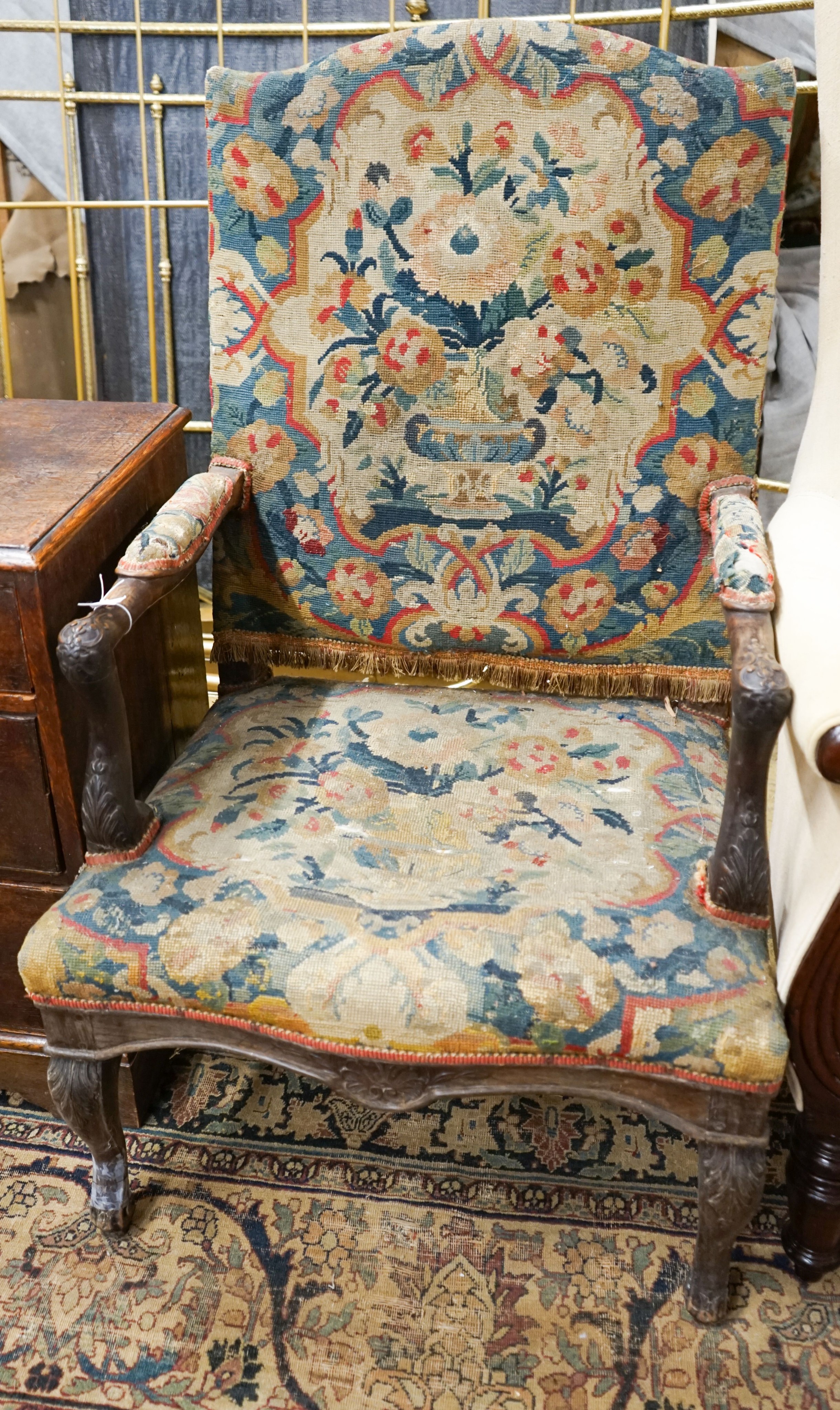 An 18th century French carved walnut elbow chair with tapestry upholstery, width 60cm, depth 58cm, height 104cm